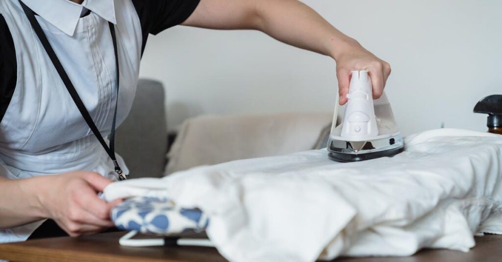 A housekeeper in uniform ironing clothes on a board indoors, focusing on housework.